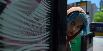 Movie still from “Kimi” (2022), directed by Steven Soderbergh – A woman with blue hair looking out of a window; Close Up shot, Low angle