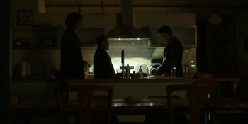 Movie still from “Kimi” (2022), directed by Steven Soderbergh – A group of people standing around a kitchen; Wide shot, Low angle