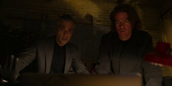 Movie still from “Kimi” (2022), directed by Steven Soderbergh – A couple of men sitting next to each other in a room; Medium shot, Low angle