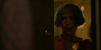 Movie still from “Kimi” (2022), directed by Steven Soderbergh – A woman standing in front of an open door; Close Up shot, Over the shoulder angle