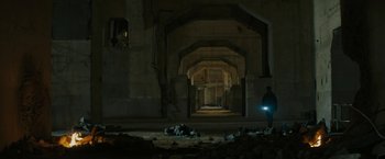 Movie still from “Kin” (2018), directed by Josh Baker – A man is standing in a dark room with a flashlight; Extreme Wide shot, Low angle