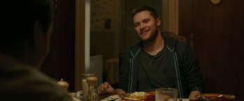Movie still from “Kin” (2018), directed by Josh Baker – A man sitting at a table with food in front of him; Medium shot, Over the shoulder angle