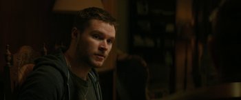 Movie still from “Kin” (2018), directed by Josh Baker – A person wearing a necklace; Close Up shot, Over the shoulder angle