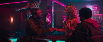 Movie still from “Kin” (2018), directed by Josh Baker – A man and a woman holding hands at a table; Medium shot, Over the shoulder angle