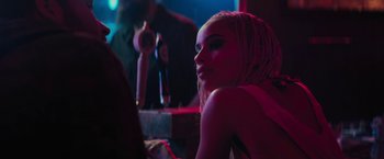 Movie still from “Kin” (2018), directed by Josh Baker – A woman sitting in front of a mirror in a dark room; Close Up shot, Over the shoulder angle