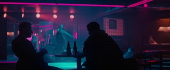 Movie still from “Kin” (2018), directed by Josh Baker – A man sitting at a table in a dark room; Wide shot, Over the shoulder angle