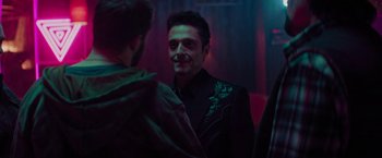 Movie still from “Kin” (2018), directed by Josh Baker – A man in a black jacket talking to another man in a green jacket; Medium shot, Over the shoulder angle