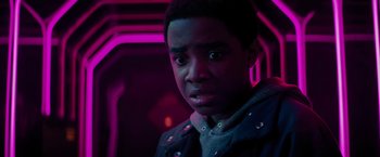 Movie still from “Kin” (2018), directed by Josh Baker – A person in a dark room; Close Up shot, Over the shoulder angle