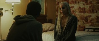 Movie still from “Kin” (2018), directed by Josh Baker – Two people sitting on a bed talking to each other; Close Up shot, Over the shoulder angle