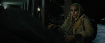 Movie still from “Kin” (2018), directed by Josh Baker – A woman with long blonde hair sitting at a table with a drink; Close Up shot, Over the shoulder angle