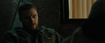 Movie still from “Kin” (2018), directed by Josh Baker – A person sitting in front of a window; Close Up shot, Over the shoulder angle