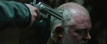 Movie still from “Kin” (2018), directed by Josh Baker – A man getting his head shaved by a man with a gun on top of his head; Extreme Close Up shot, Over the shoulder angle