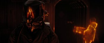 Movie still from “Kin” (2018), directed by Josh Baker – A person wearing a helmet in a dark room; Close Up shot, Over the shoulder angle