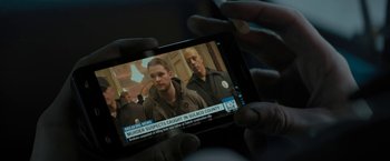 Movie still from “Kin” (2018), directed by Josh Baker – A person is holding a cell phone in their hand; Extreme Close Up shot, High angle