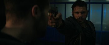 Movie still from “Kin” (2018), directed by Josh Baker – A man holding a gun in front of a mirror; Close Up shot, Over the shoulder angle