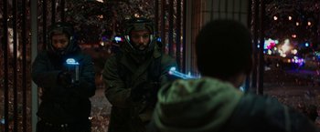 Movie still from “Kin” (2018), directed by Josh Baker – A man in a gas mask is talking to someone; Medium shot, Over the shoulder angle