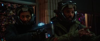 Movie still from “Kin” (2018), directed by Josh Baker – A man and a woman are playing a video game; Medium shot, Over the shoulder angle