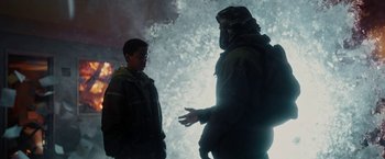 Movie still from “Kin” (2018), directed by Josh Baker – Two people standing next to each other in front of a wall; Medium shot, Over the shoulder angle