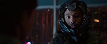 Movie still from “Kin” (2018), directed by Josh Baker – A man wearing a helmet in a dark room; Close Up shot, Over the shoulder angle