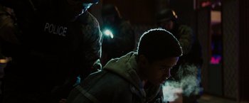 Movie still from “Kin” (2018), directed by Josh Baker – A young boy is looking down at a flashlight; Medium shot, Over the shoulder angle