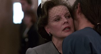 Movie still from “Kindergarten Cop” (1990), directed by Ivan Reitman – An older woman wearing a hat and a veil; Close Up shot, Over the shoulder angle