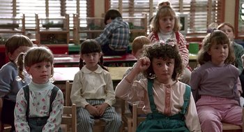 Movie still from “Kindergarten Cop” (1990), directed by Ivan Reitman – A group of children sitting in a classroom; Medium shot, High angle