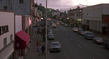 Movie still from “Kindergarten Cop” (1990), directed by Ivan Reitman – A city street with many cars on the side of the road; Extreme Wide shot, High angle