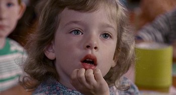 Movie still from “Kindergarten Cop” (1990), directed by Ivan Reitman – A child with her hand to her mouth; Close Up shot, High angle