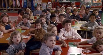 Movie still from “Kindergarten Cop” (1990), directed by Ivan Reitman – A group of children sitting at a table in a classroom; Medium shot, High angle