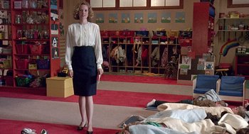 Movie still from “Kindergarten Cop” (1990), directed by Ivan Reitman – A woman standing in front of a group of people; Wide shot, High angle