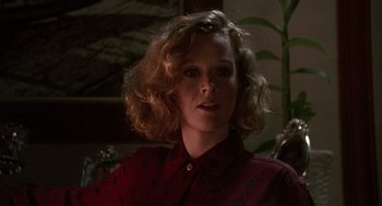 Movie still from “Kindergarten Cop” (1990), directed by Ivan Reitman – A woman in a red shirt is looking at the camera; Close Up shot, Low angle