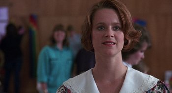 Movie still from “Kindergarten Cop” (1990), directed by Ivan Reitman – A person wearing a white shirt; Close Up shot, Low angle