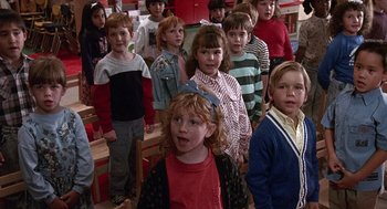 Movie still from “Kindergarten Cop” (1990), directed by Ivan Reitman – A group of children standing in a room together; Medium shot, High angle