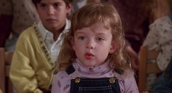Movie still from “Kindergarten Cop” (1990), directed by Ivan Reitman – A little girl with long hair and a pink shirt; Close Up shot, High angle