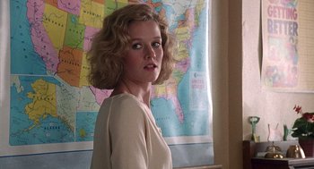 Movie still from “Kindergarten Cop” (1990), directed by Ivan Reitman – A woman standing in front of a map of the united states; Close Up shot, Low angle