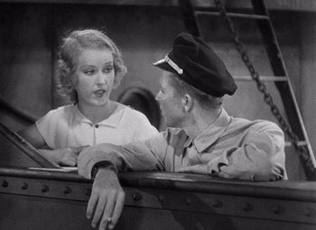 Movie still from “King Kong” (1933), directed by Merian C. Cooper – A man and a woman sitting next to each other on a boat; Medium shot, Over the shoulder angle