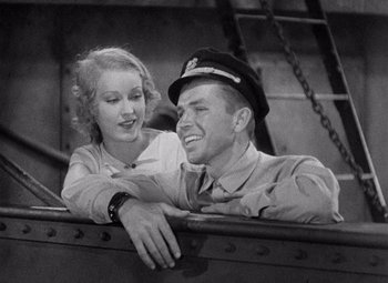 Movie still from “King Kong” (1933), directed by Merian C. Cooper – A man and a woman sitting next to each other on a boat; Medium shot, High angle