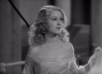 Movie still from “King Kong” (1933), directed by Merian C. Cooper – A black - and - white photo of a woman in a white dress; Close Up shot, Over the shoulder angle
