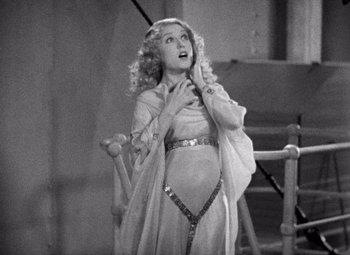 Movie still from “King Kong” (1933), directed by Merian C. Cooper – A black - and - white photo of a woman in a dress; Medium shot, High angle