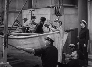 Movie still from “King Kong” (1933), directed by Merian C. Cooper – A black and white photo of men in a boat; Wide shot, High angle