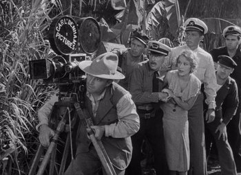 Movie still from “King Kong” (1933), directed by Merian C. Cooper – A black and white photo of a group of people standing next to each other; Wide shot, High angle