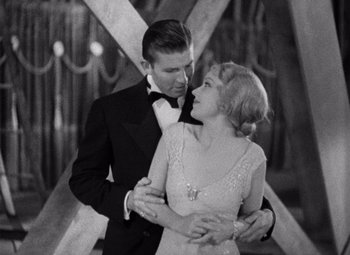 Movie still from “King Kong” (1933), directed by Merian C. Cooper – A man and a woman are dancing together in formal wear; Medium shot, Low angle