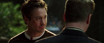 Movie still from “Kiss Kiss Bang Bang” (2005), directed by Shane Black – A man with a knife on his face looking at another man with blood on his face; Close Up shot, Over the shoulder angle