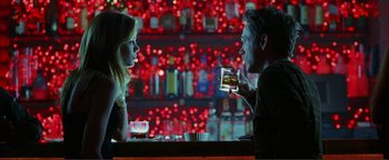 Movie still from “Kiss Kiss Bang Bang” (2005), directed by Shane Black – A man and a woman sitting at a bar; Medium shot, Over the shoulder angle
