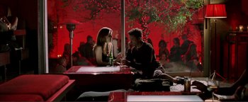 Movie still from “Kiss Kiss Bang Bang” (2005), directed by Shane Black – A man and a woman are sitting at a table together; Wide shot, High angle