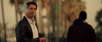 Movie still from “Kiss Kiss Bang Bang” (2005), directed by Shane Black – A person smoking a cigarette; Close Up shot, Over the shoulder angle