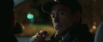 Movie still from “Kiss Kiss Bang Bang” (2005), directed by Shane Black – A person holding a cell phone; Close Up shot, Over the shoulder angle