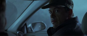 Movie still from “Kiss Kiss Bang Bang” (2005), directed by Shane Black – A person sitting in a car; Close Up shot, Over the shoulder angle