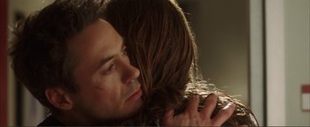Movie still from “Kiss Kiss Bang Bang” (2005), directed by Shane Black – A person hugging another person; Close Up shot, Over the shoulder angle