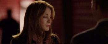 Movie still from “Kiss Kiss Bang Bang” (2005), directed by Shane Black – A beautiful young woman with long , red hair; Close Up shot, Over the shoulder angle